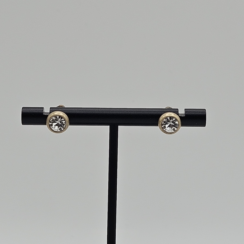 Clear crystal earrings in frosted gold tone metal